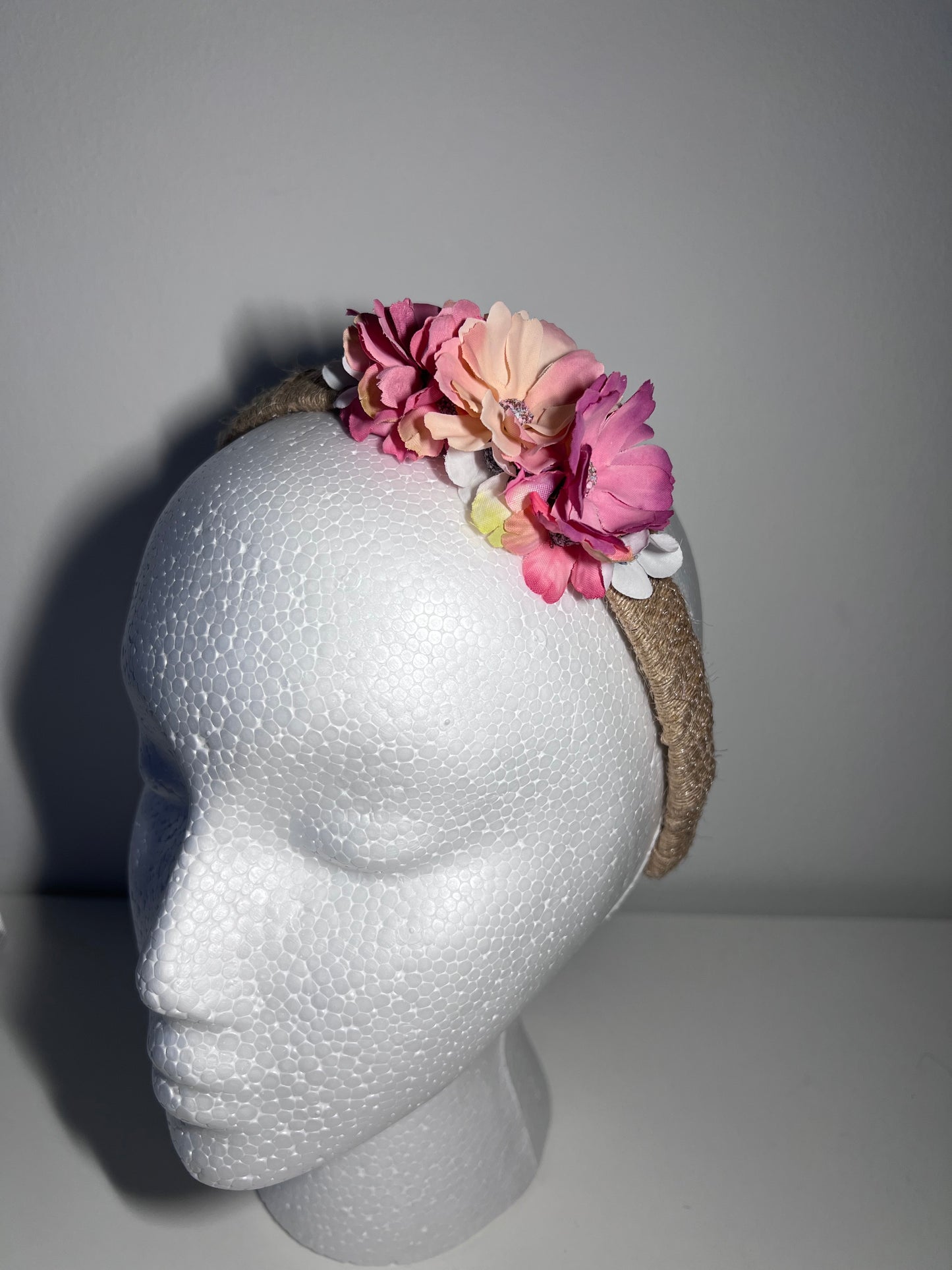 Handmade jute ribbon on plastic headband with flowers.