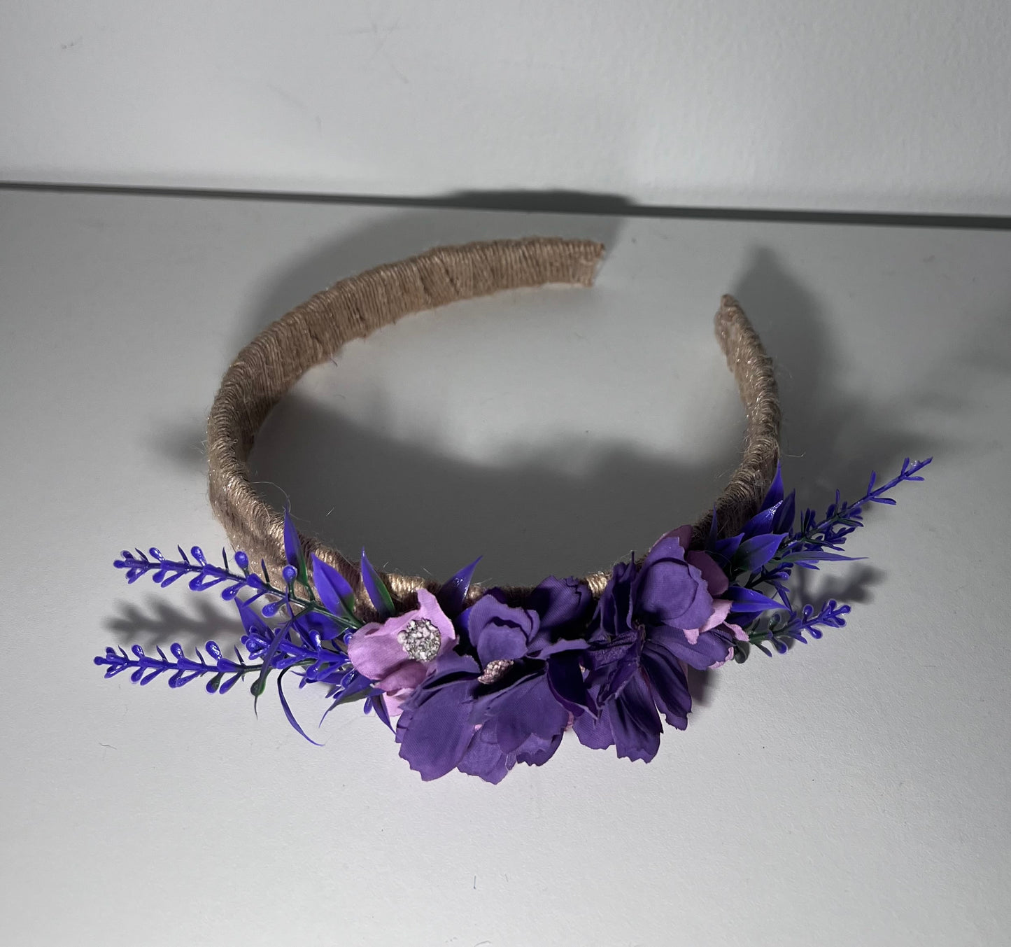 Handmade jute ribbon on plastic headband with flowers.