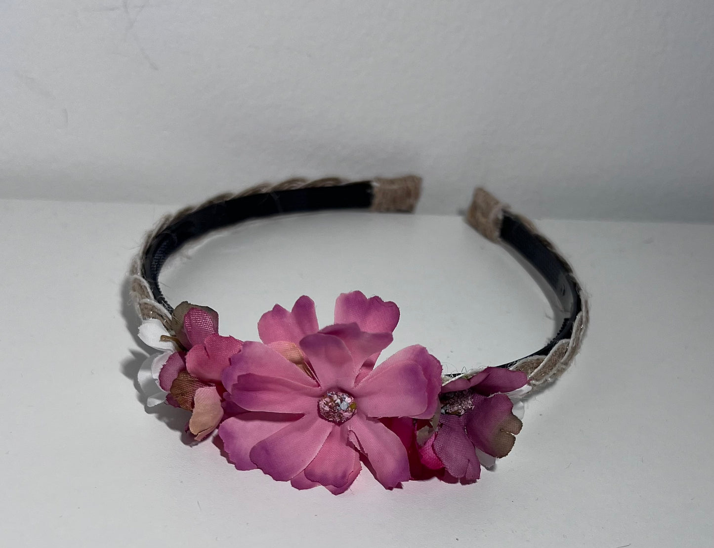 Handmade braided jute ribbon on plastic headband with flowers.