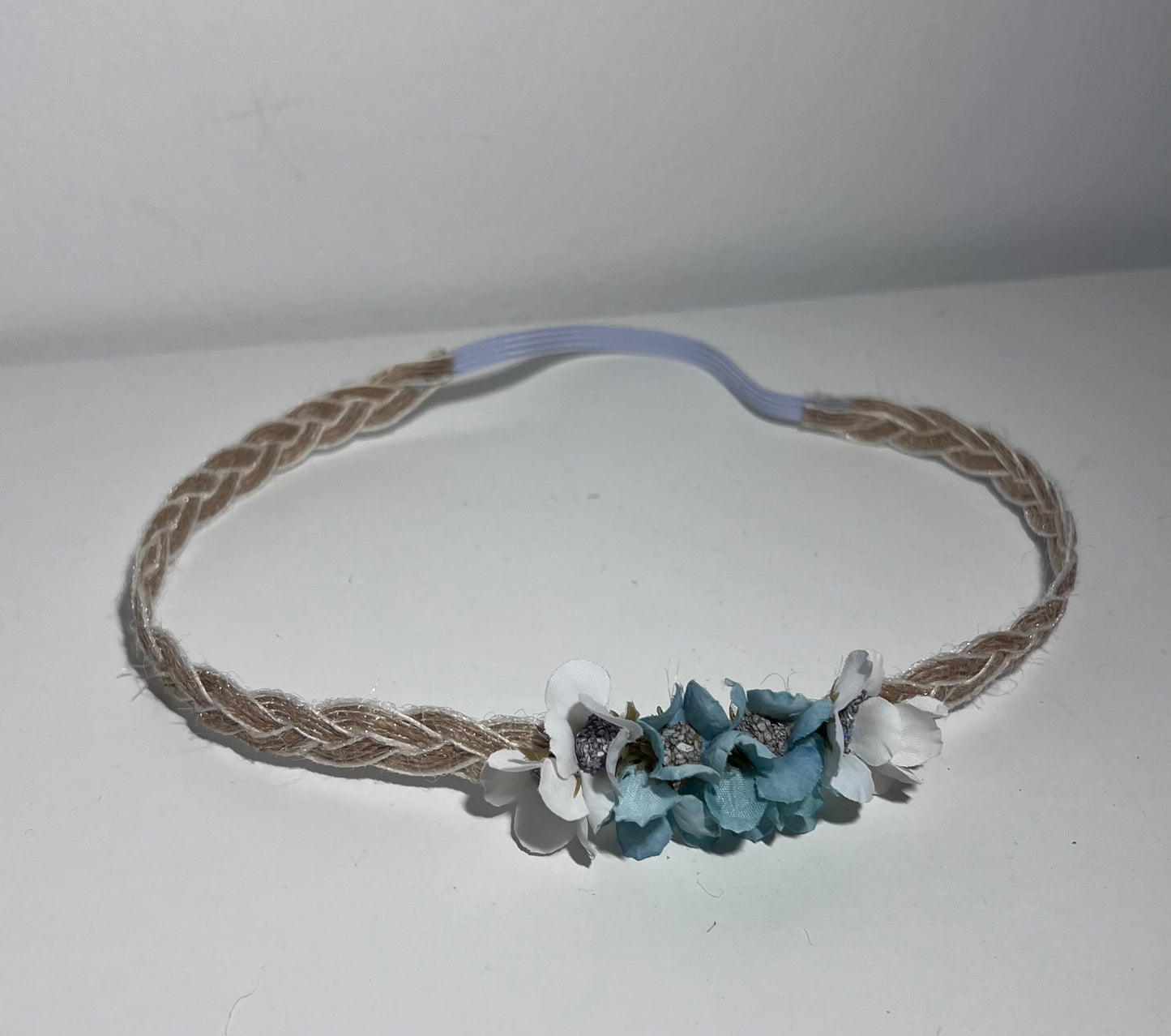 Handmade braided jute ribbon headband with flowers.