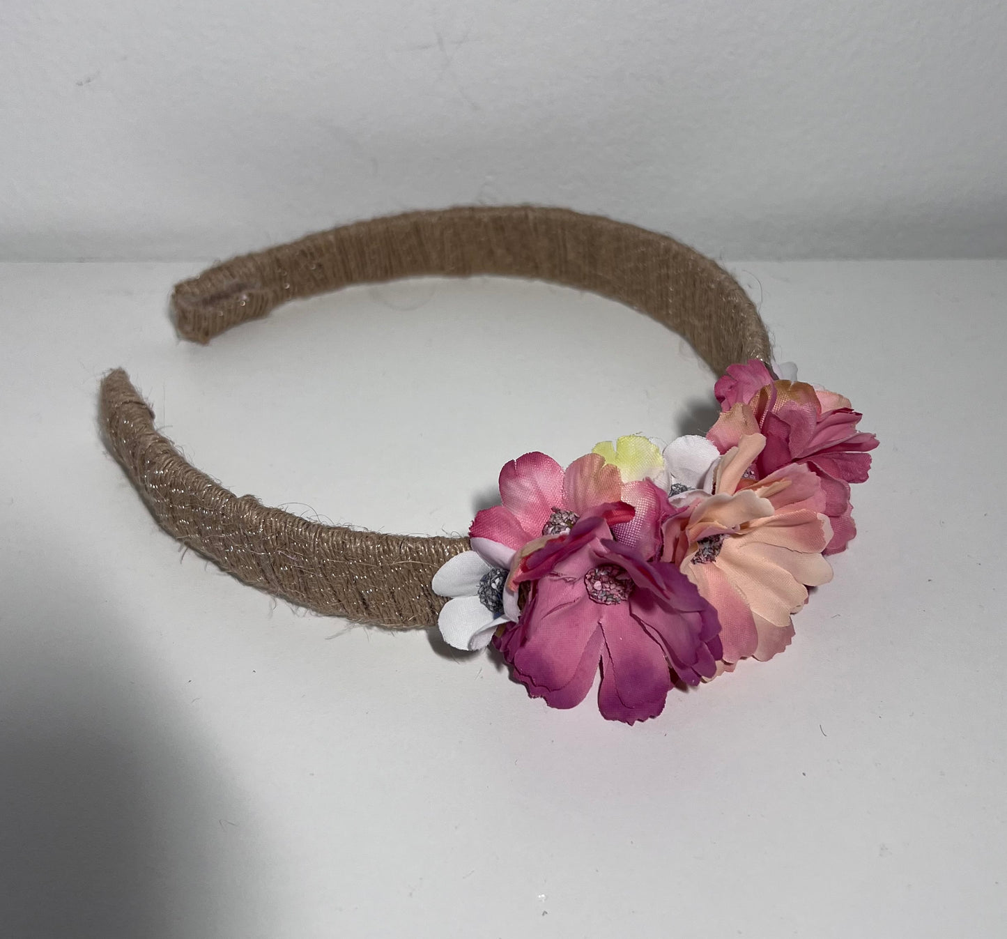 Handmade jute ribbon on plastic headband with flowers.