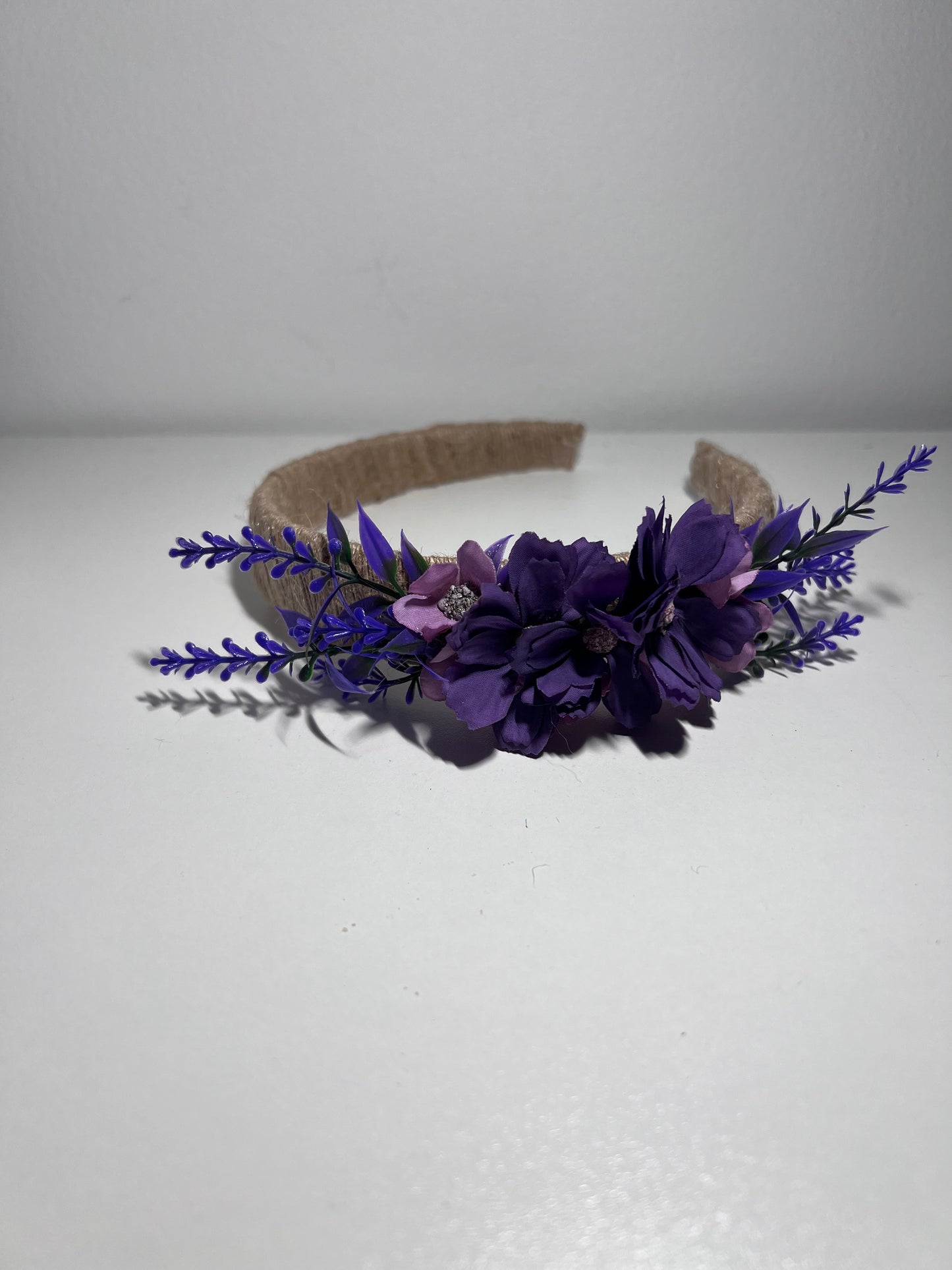 Handmade jute ribbon on plastic headband with flowers.