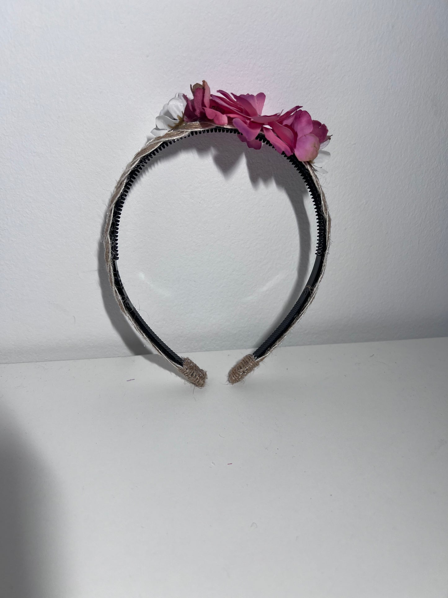 Handmade braided jute ribbon on plastic headband with flowers.