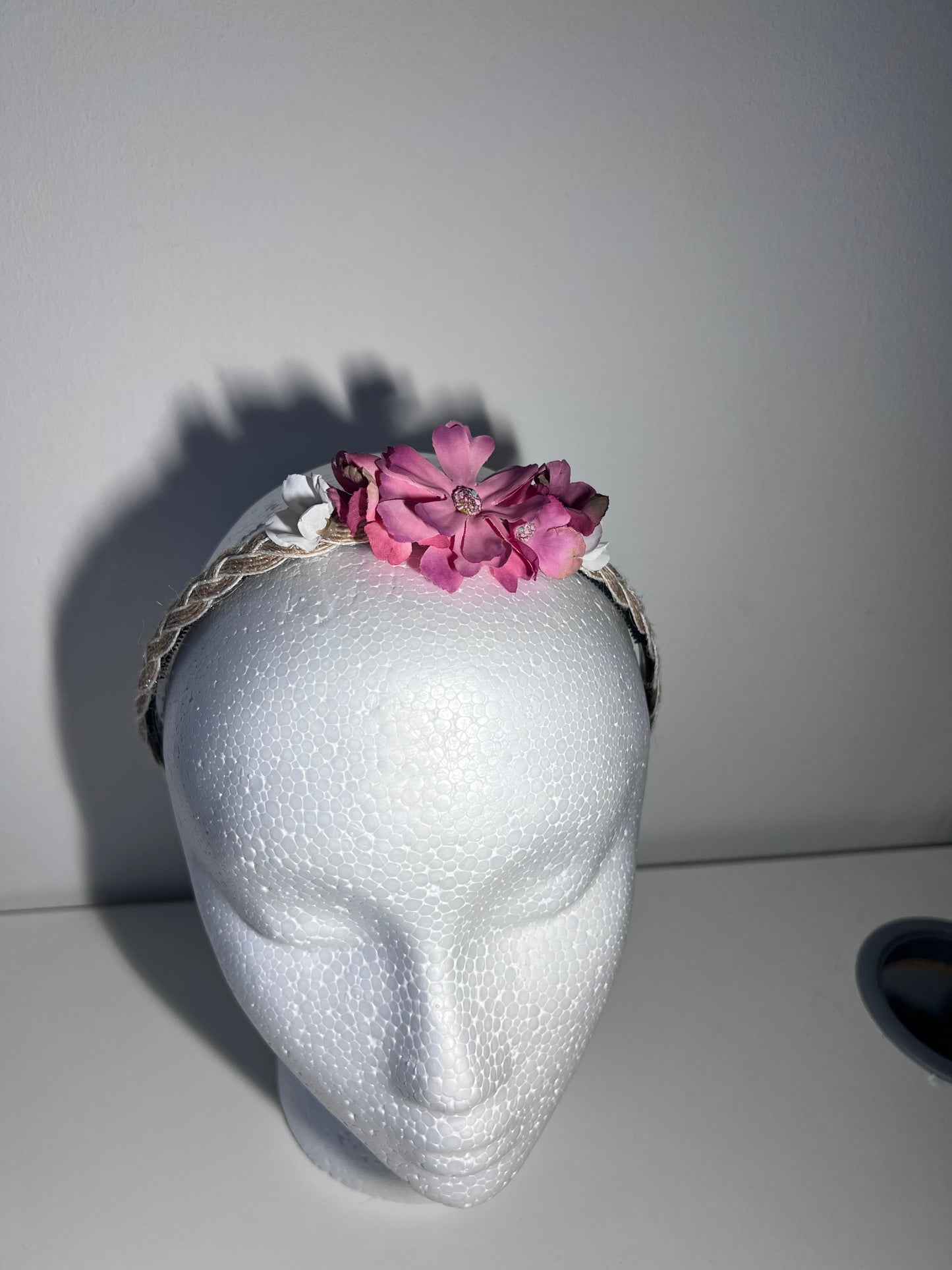 Handmade braided jute ribbon on plastic headband with flowers.