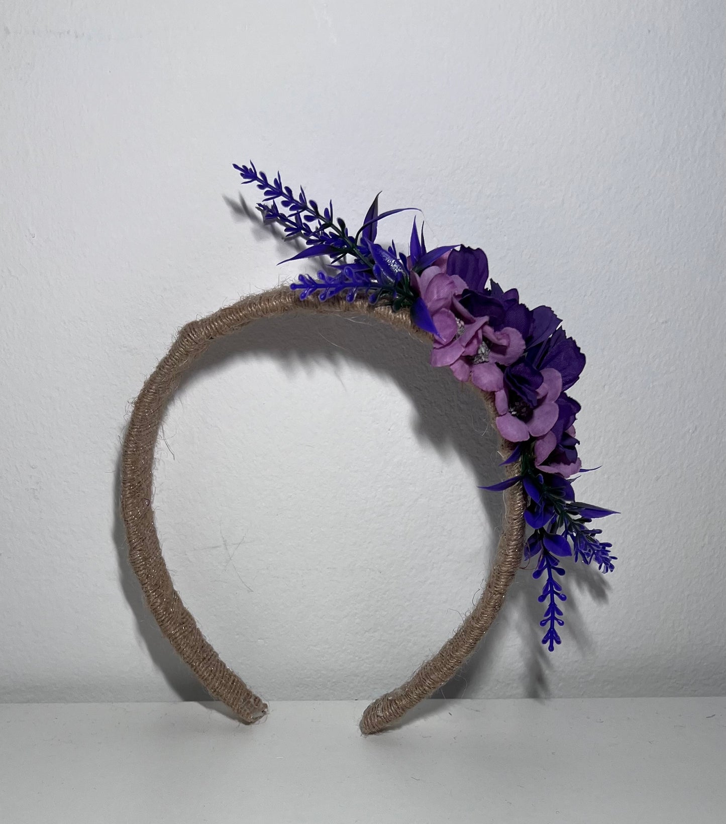 Handmade jute ribbon on plastic headband with flowers.