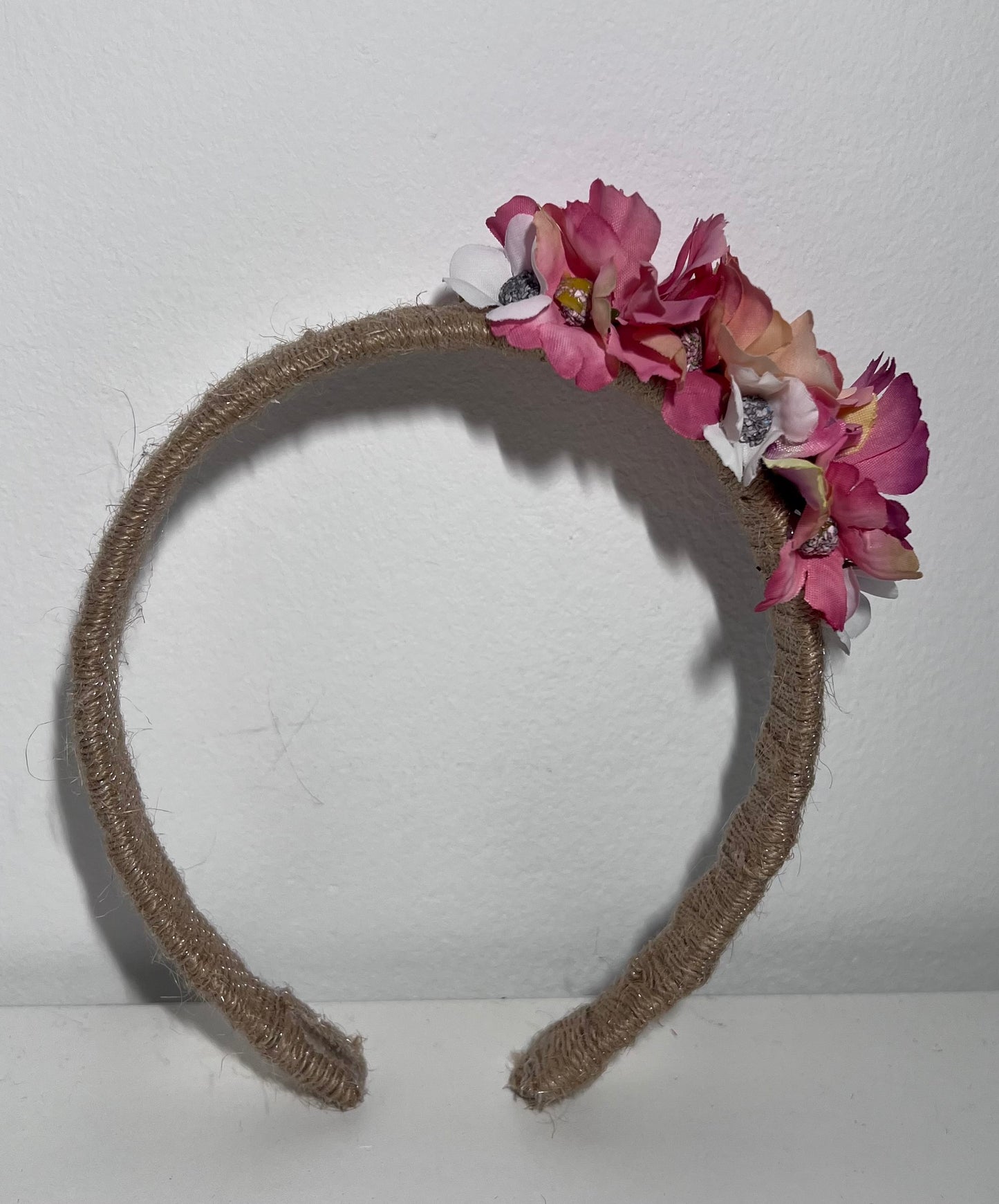 Handmade jute ribbon on plastic headband with flowers.